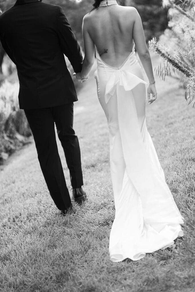 The French House bride and groom walking in the garden.