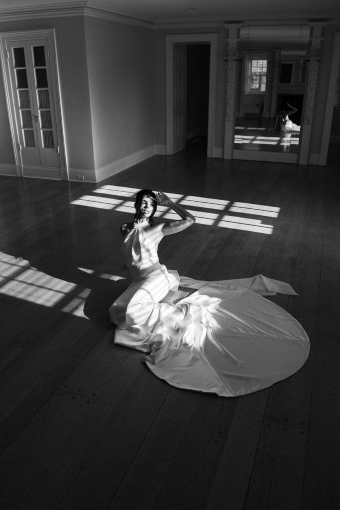 The bride posing on the floor in black in white at The French House