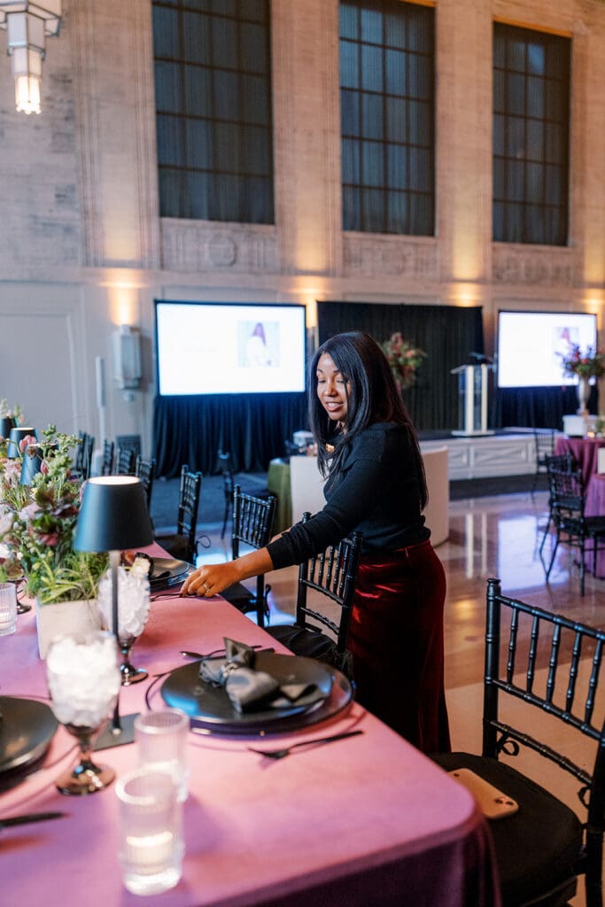 Wedding planner placing flatware at The Grande Hall for WIPA